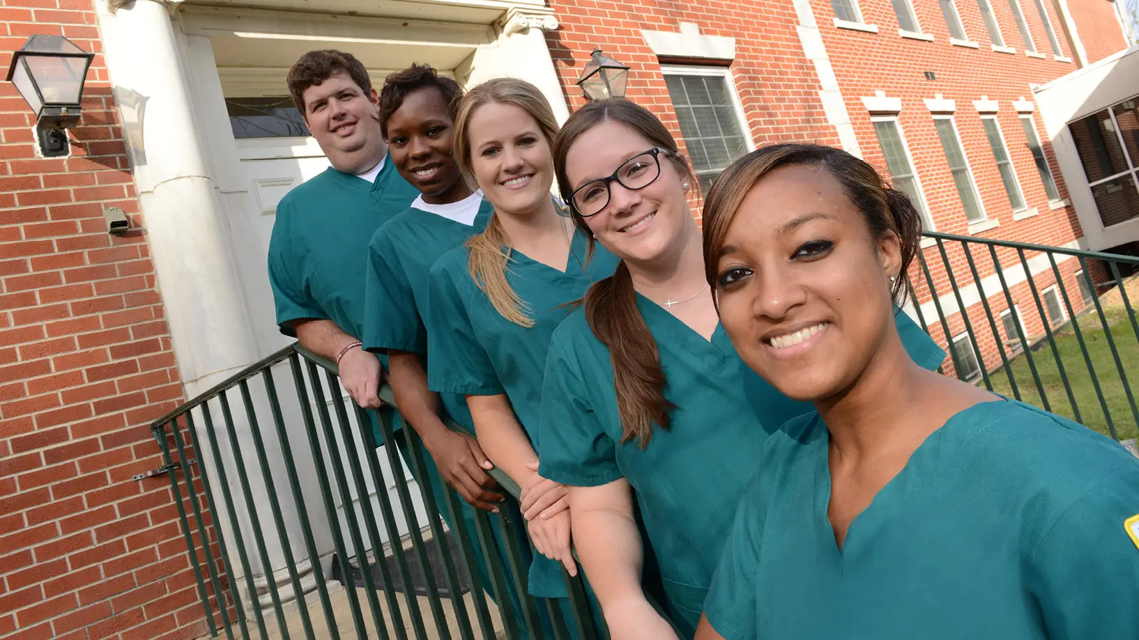 nursing students lined up on the stairs