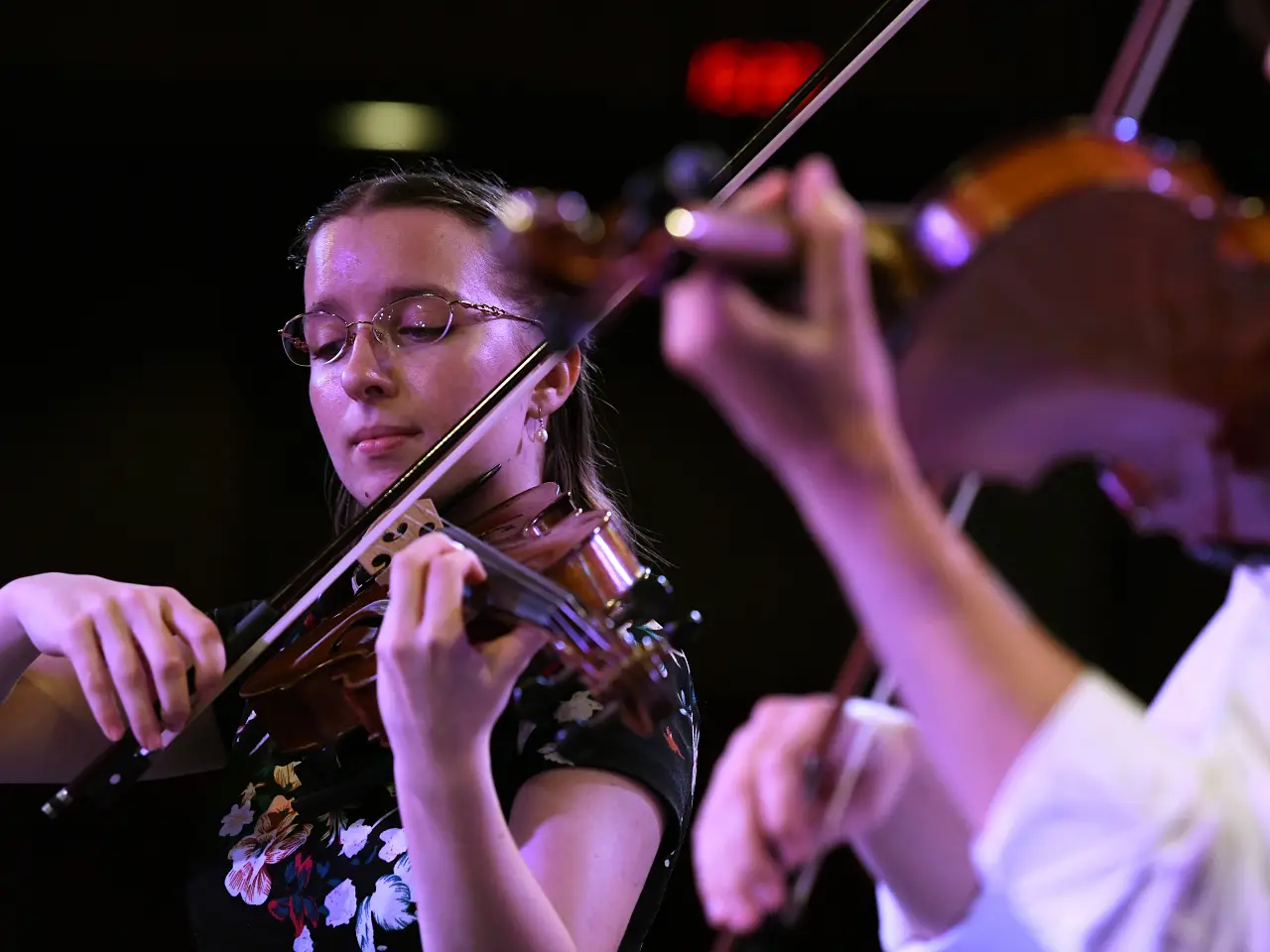 A couple of violinists performing on stage. 