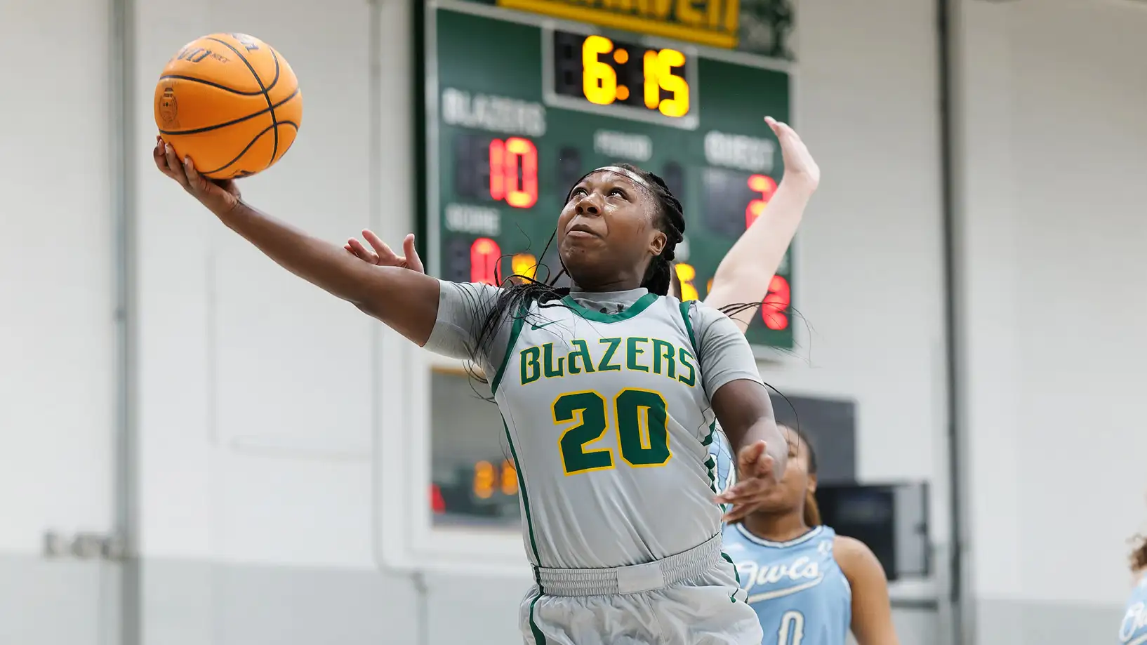 Lady Blazer shooting basketball lay up