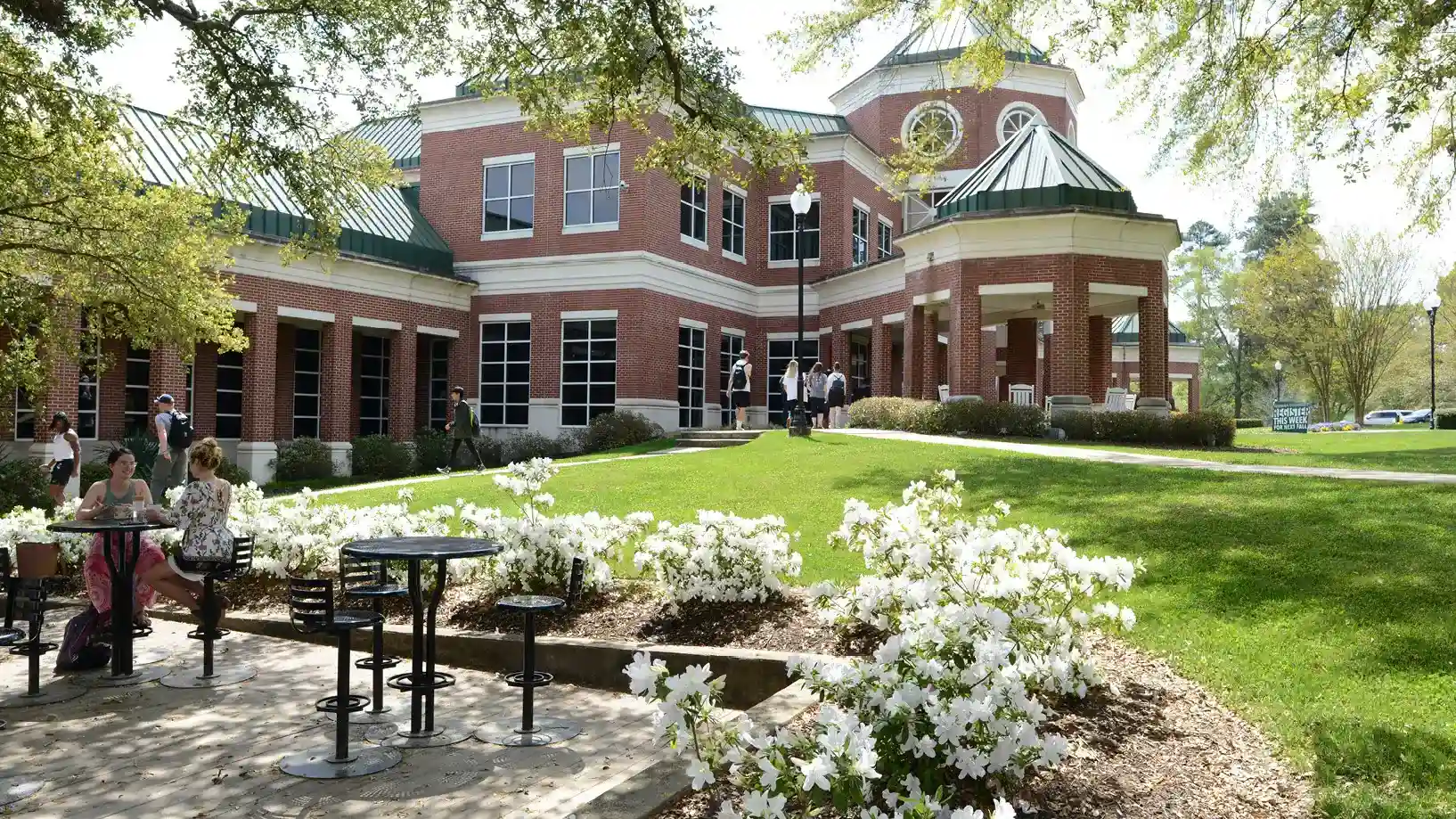 student center with white azaleas in bloom