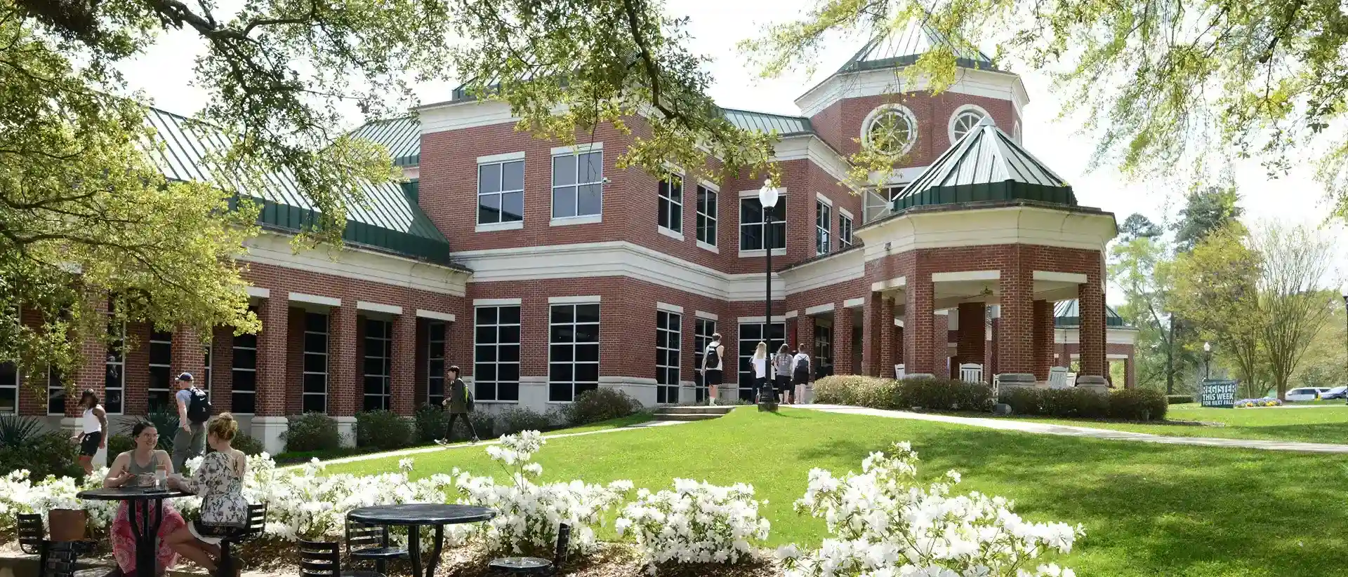 Student Center with white azaleas in bloom