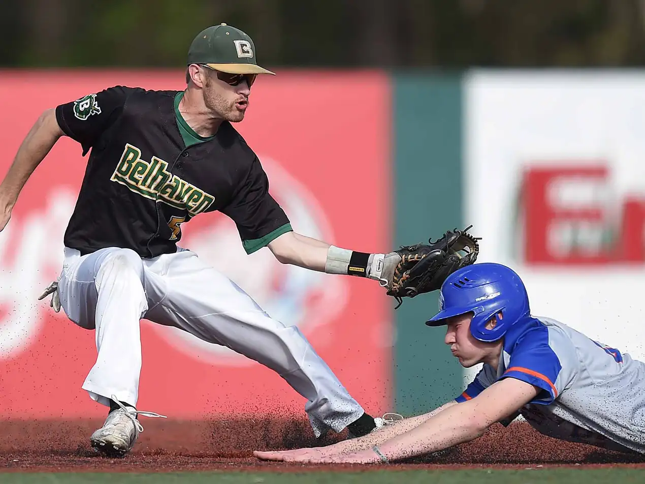 belhaven baseball player tagging out a runner who is sliding