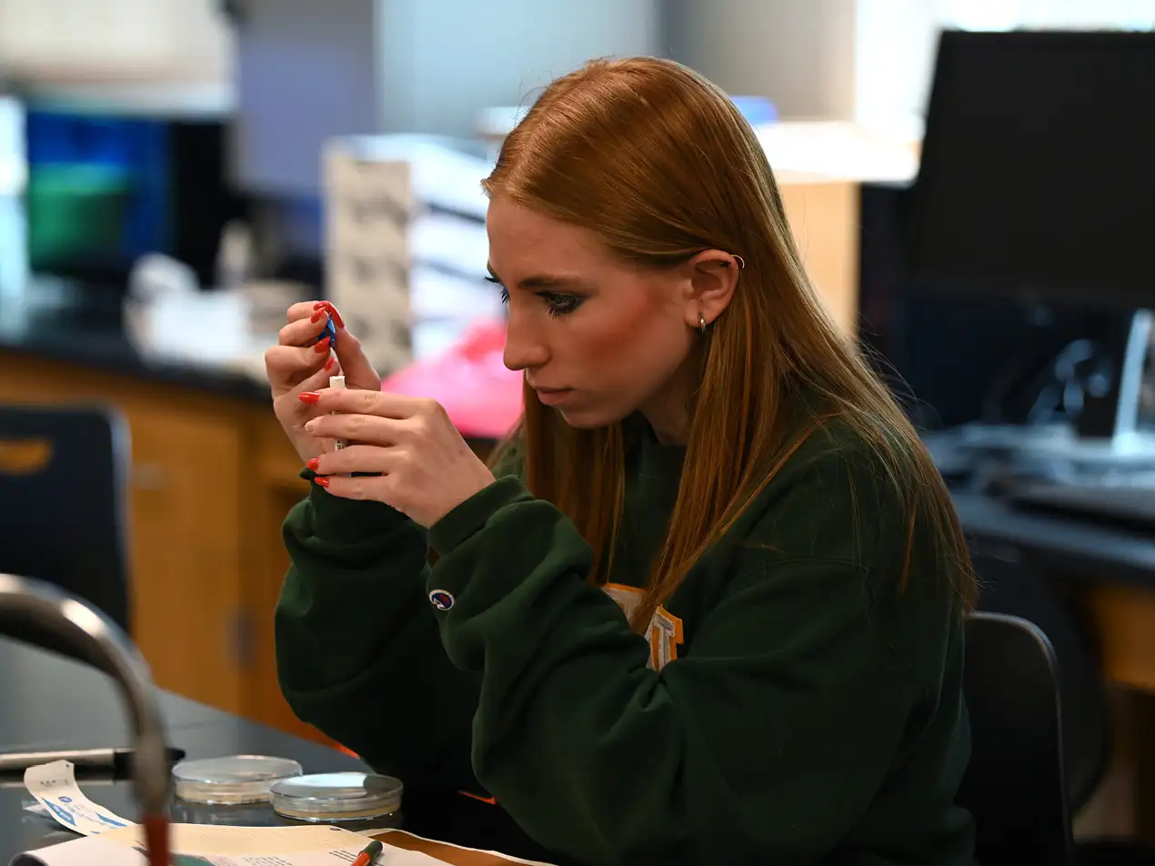 student taking a sample in biology class