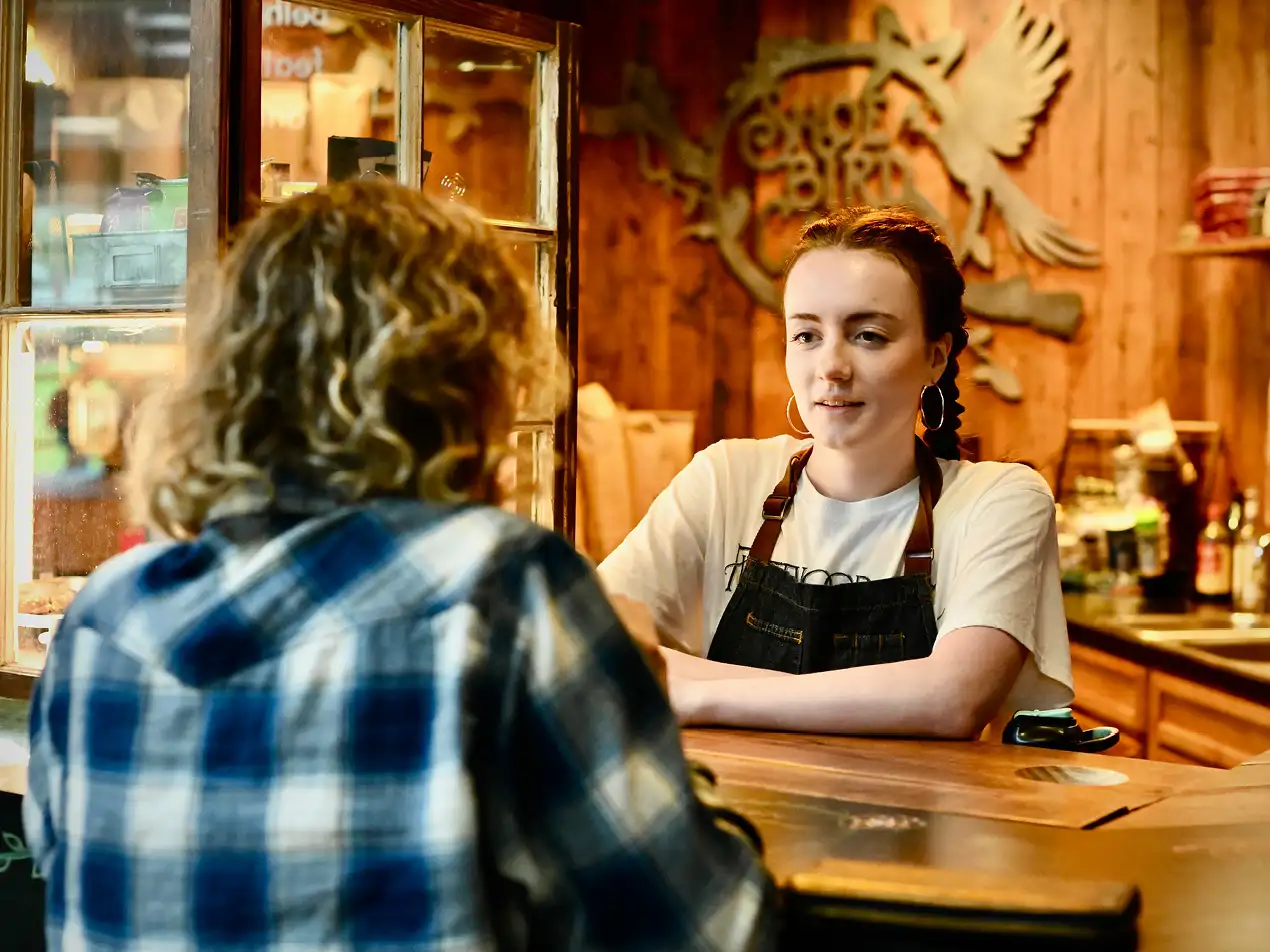 barista serving a customer at the Shoebird cafe