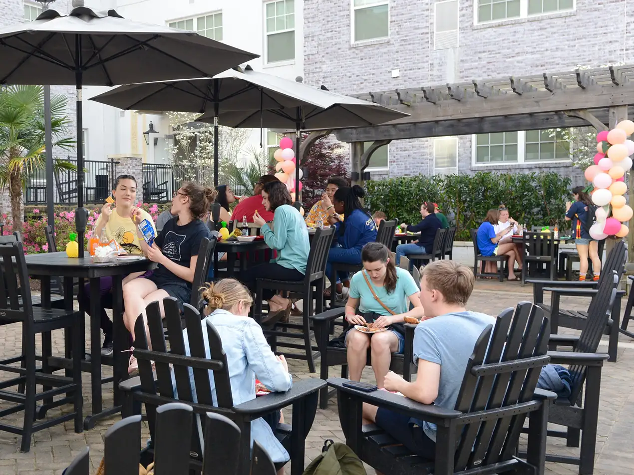 community gathering in the university village courtyard