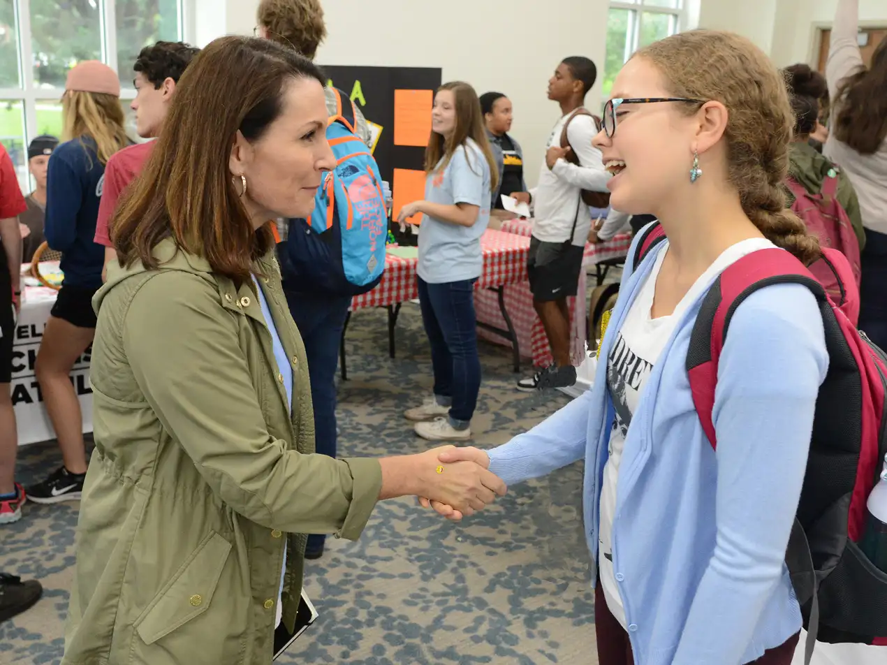a student shaking hands with Dr. Tracy Ford
