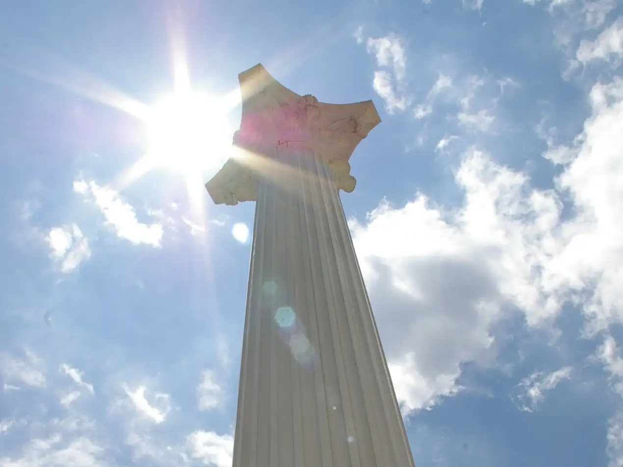 column from the bottom up with the sun above