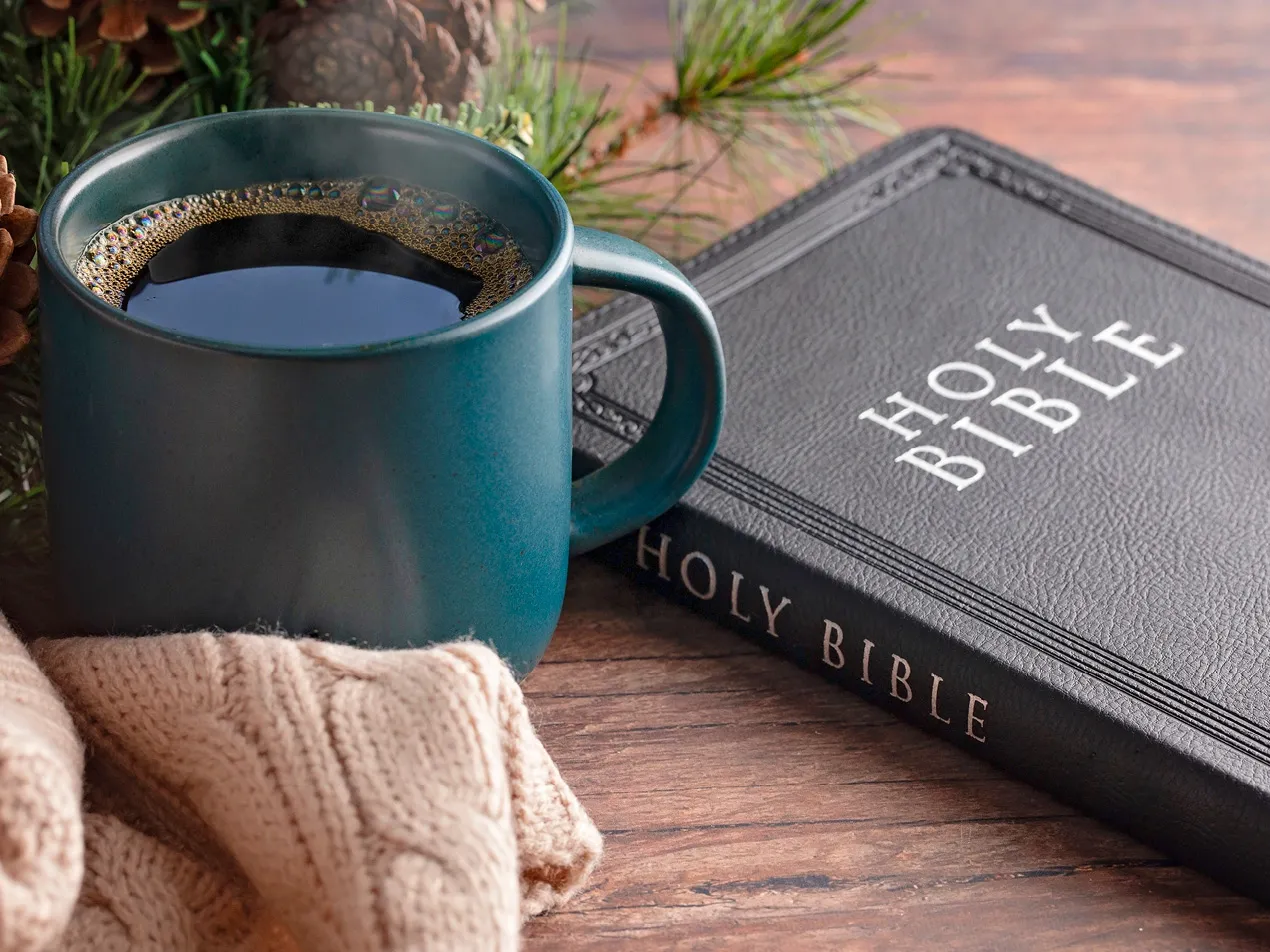 cup of coffee and bible on table
