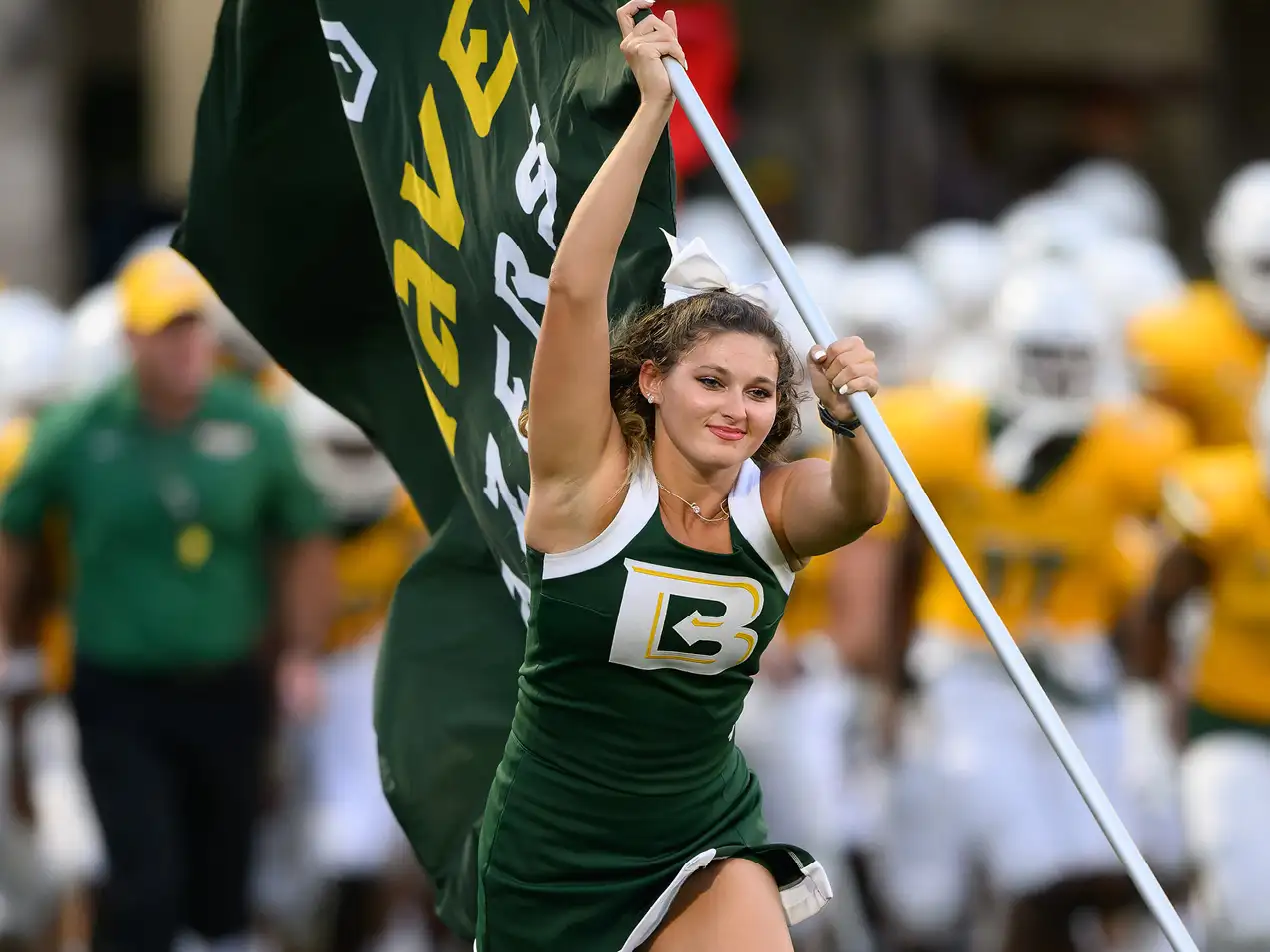 cheerleader running with flag