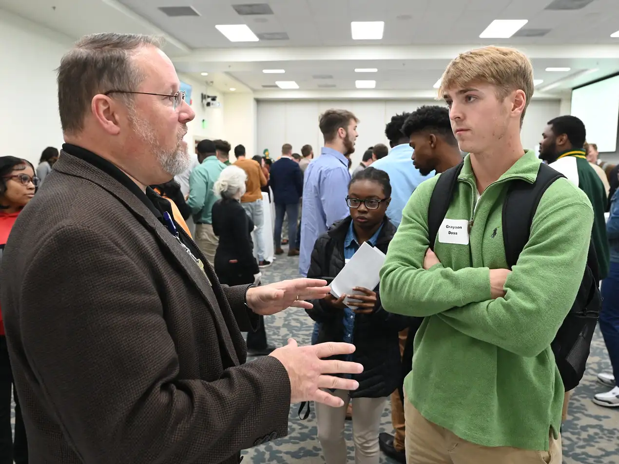 student speaking to prospective employer