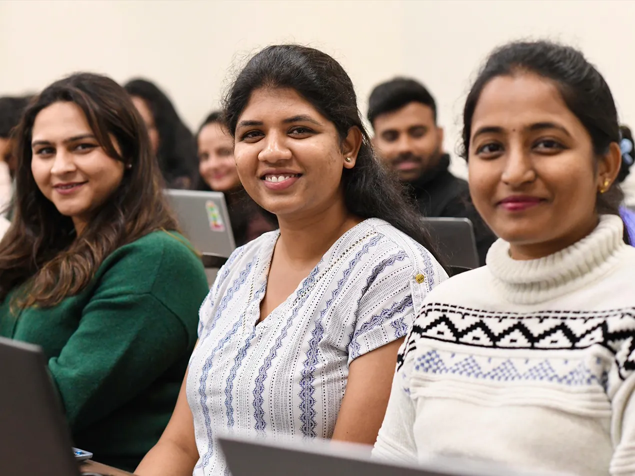 Group of international students smiling in classroom