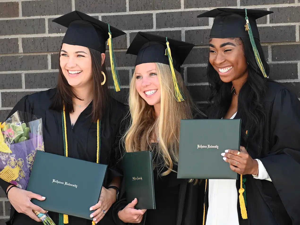 group of graduates with diplomas