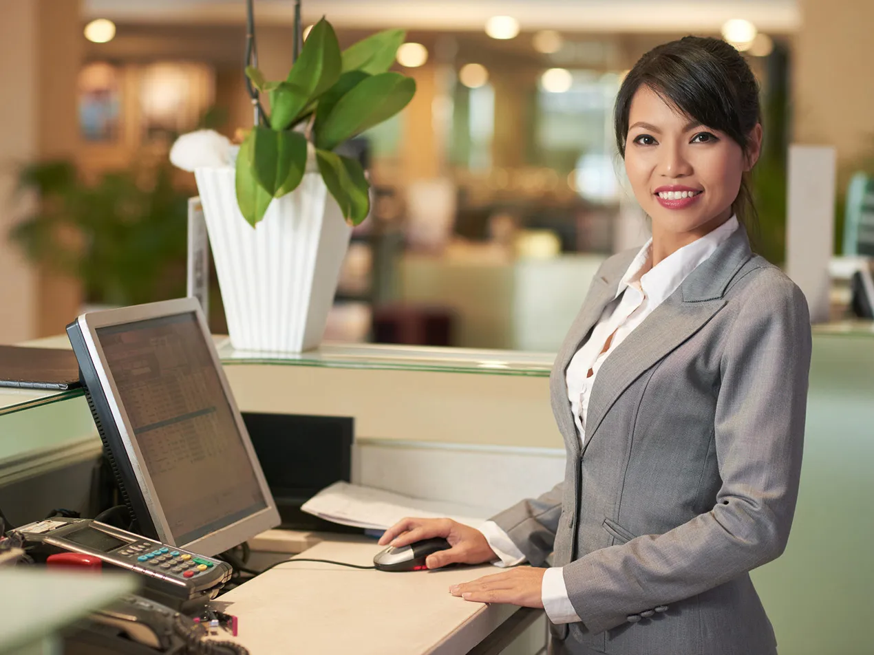 hospitality manager standing at desk