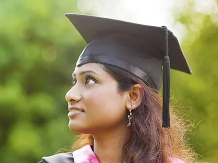 international student in graduation cap