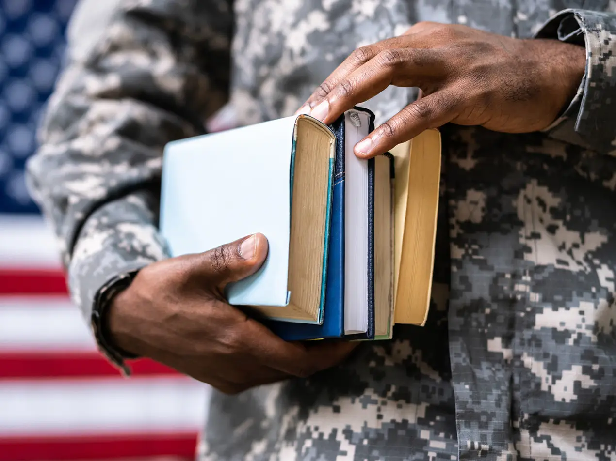military member carrying books