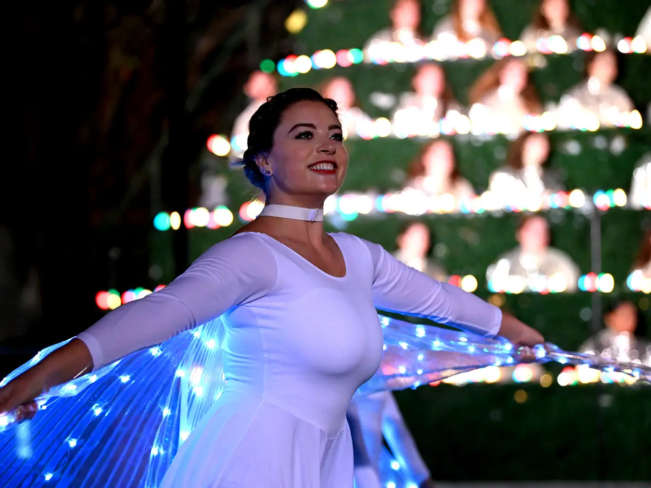 dance student dressed as angel with singing christmas tree