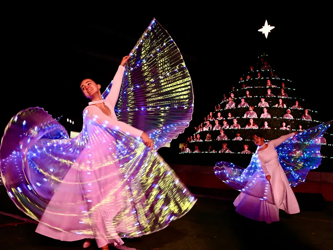 dance student dressed as angel with singing christmas tree