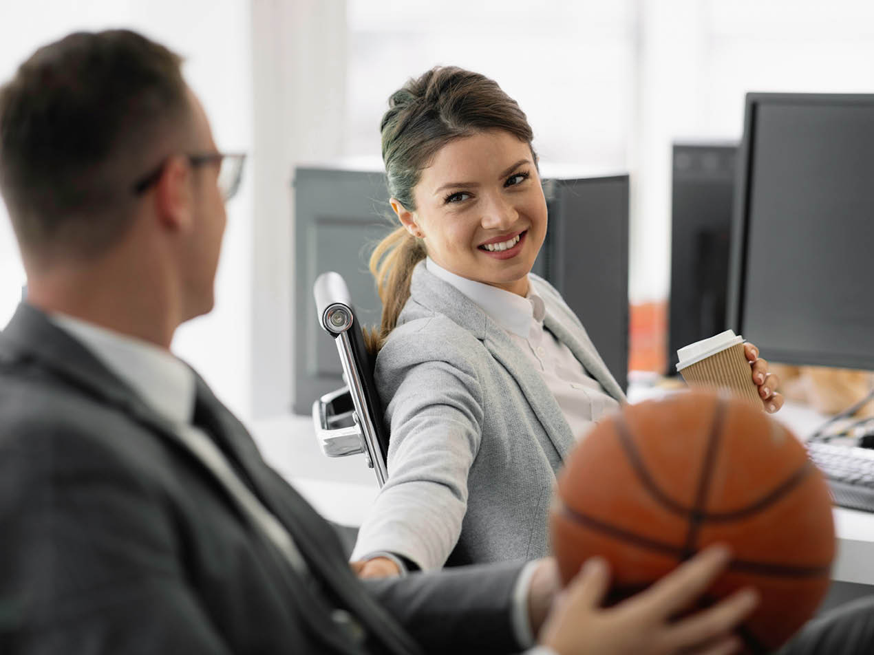 Two athletic administrators in office setting