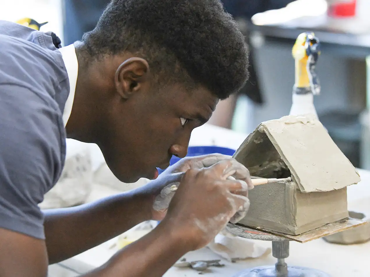 student working on sculpture project