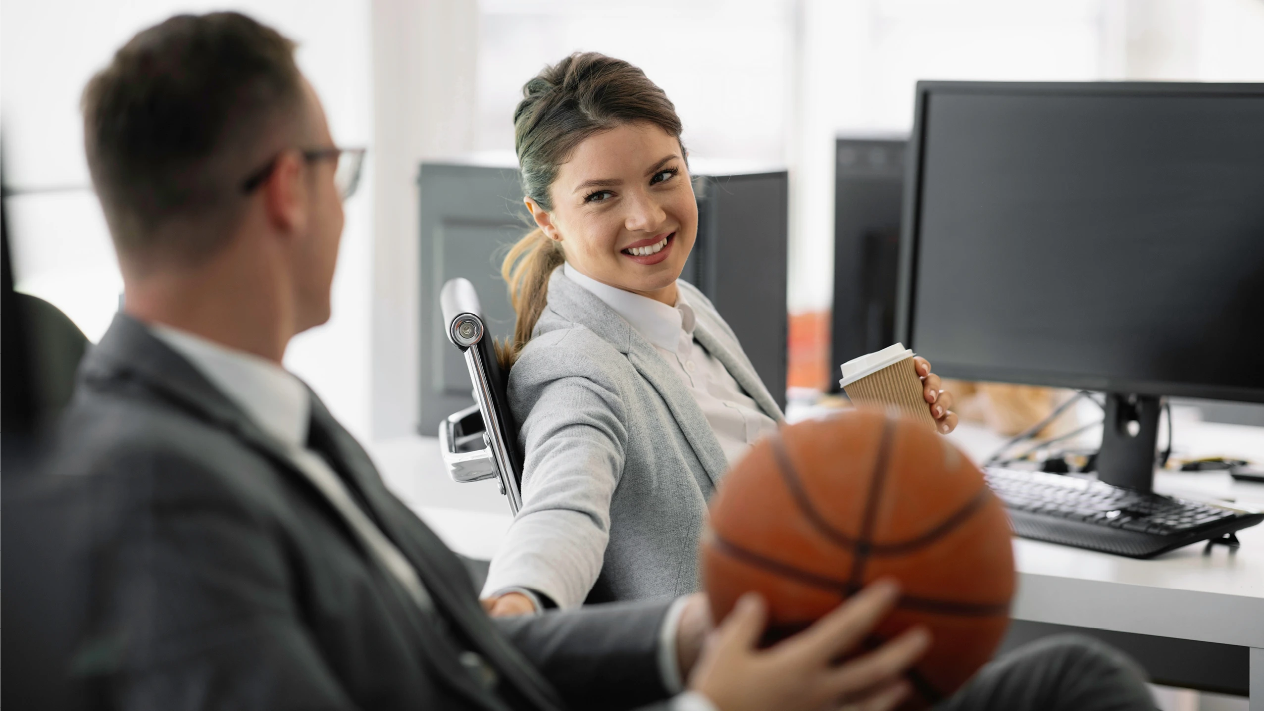 male and female sports managers smiling