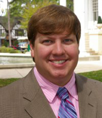 guy smiling in a pink shirt and tie