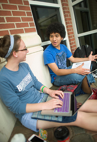 students talking on the porch