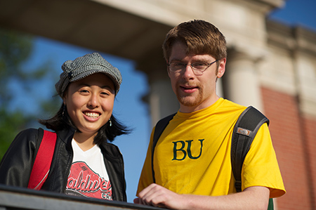 student talking near athletic field