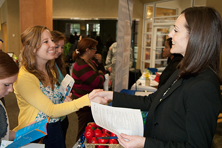Student interacting with a vendor at a career fair