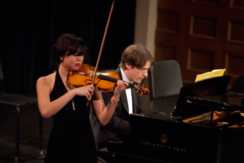 a student playing the violin and a student playing the piano
